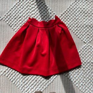 Red pleated skirt with scallop waist.